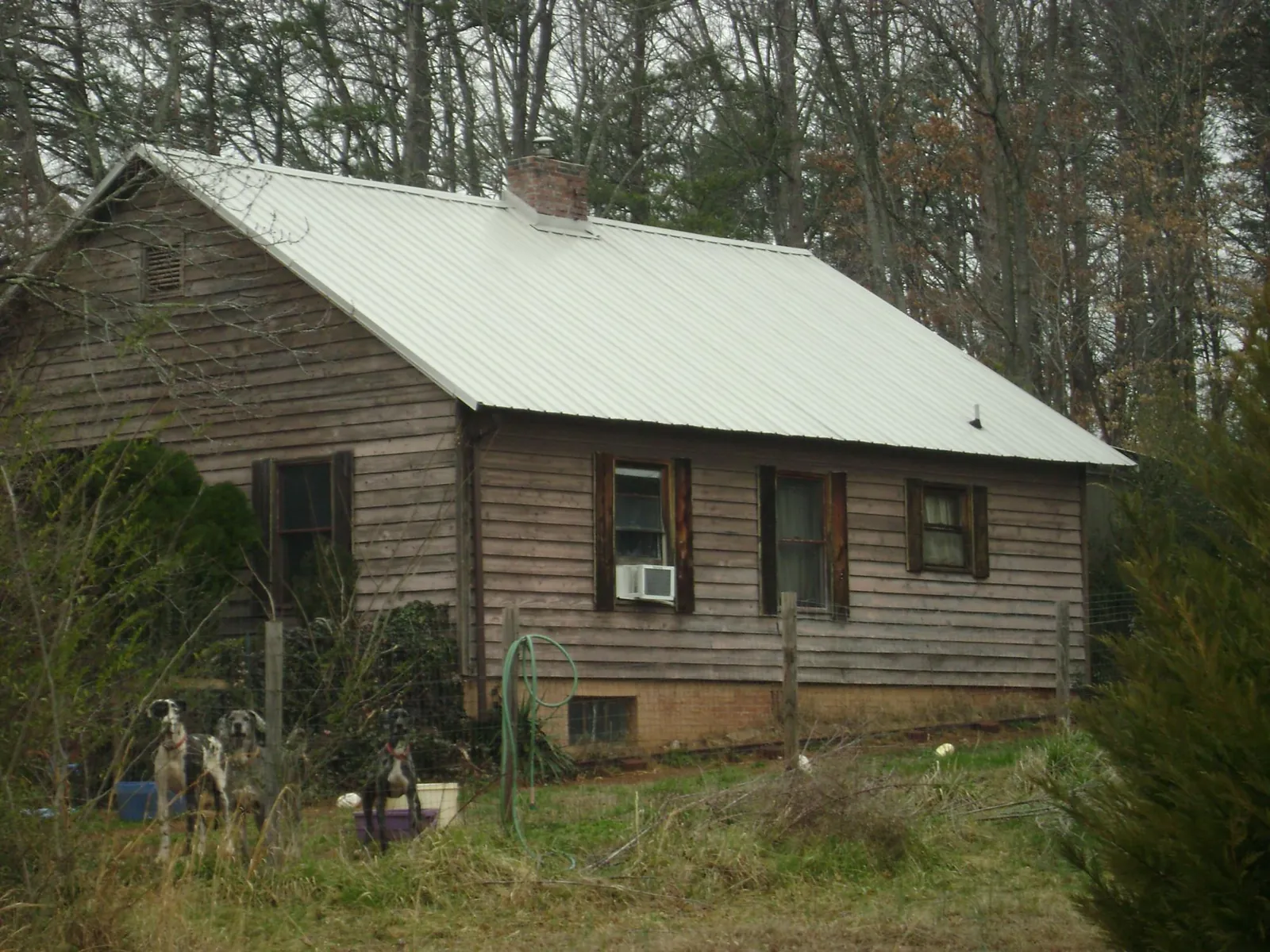 White metal roof on an old wood sided farmhouse, from a Metal Roof Installation job in Tiplersville